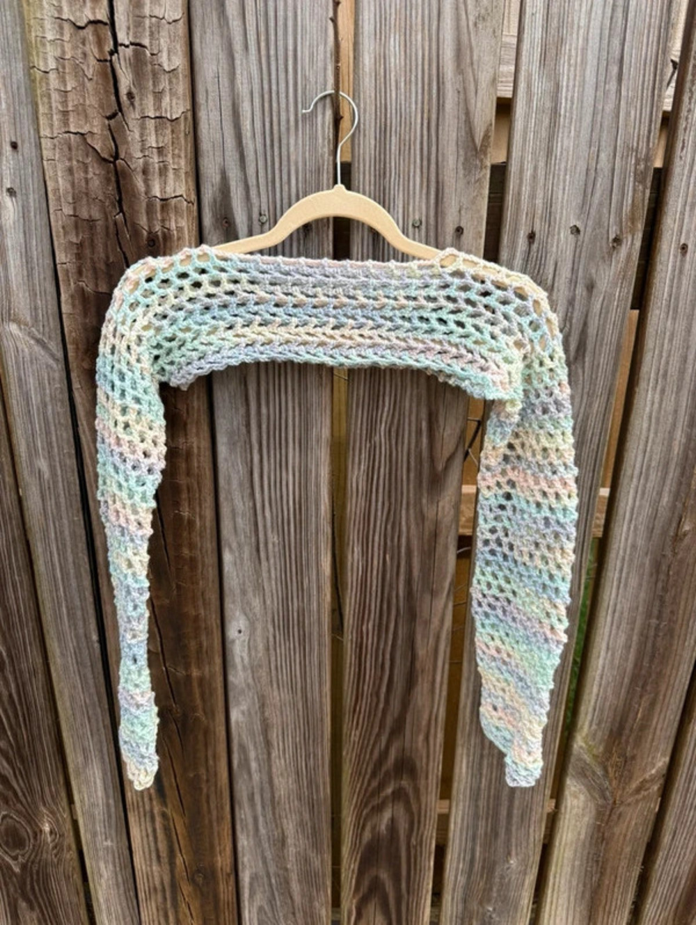 Multicoloured pastel rainbow crochet shawl shrug with a boho vibe